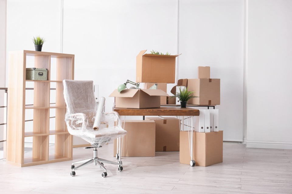 Office furniture wrapped and packed in boxes ready for a business relocation